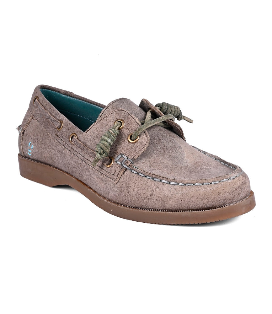 The Roan Abide women's boat shoe, crafted from brown suede with green laces and visible stitching, features a durable runner composite outsole for style and water repellency.