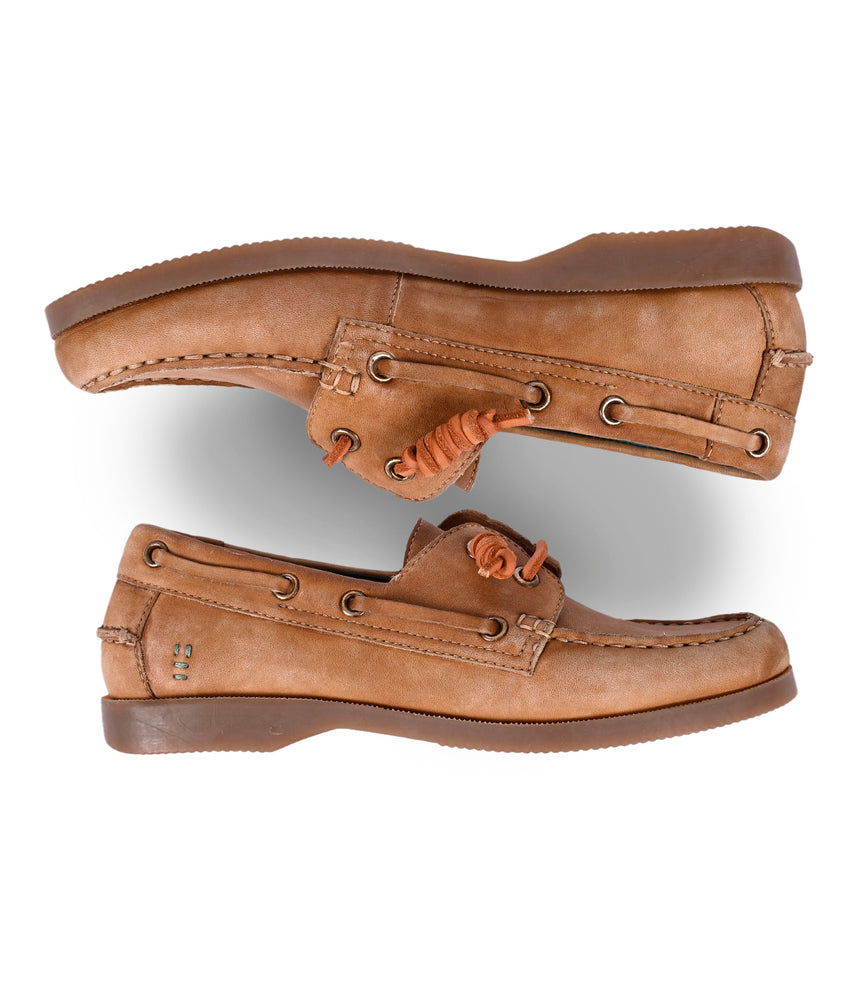 
                  
                    The Roan Abide women's leather boat shoes showcase timeless elegance with brown laces and stitching. One shoe is top side up while the other highlights its durable runner composite outsole, blending style and functionality seamlessly.
                  
                