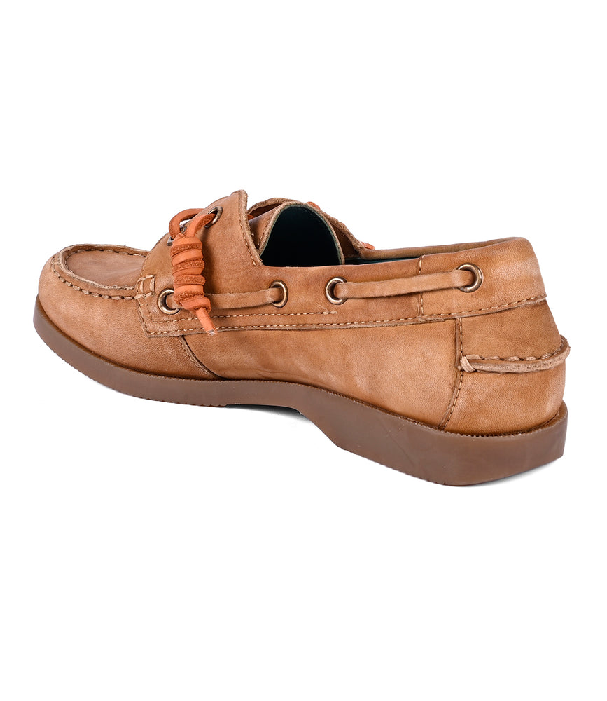 
                  
                    The Roan "Abide" women's shoe is a leather boat style in tan with brown soles, featuring elegant orange laces and side stitching.
                  
                