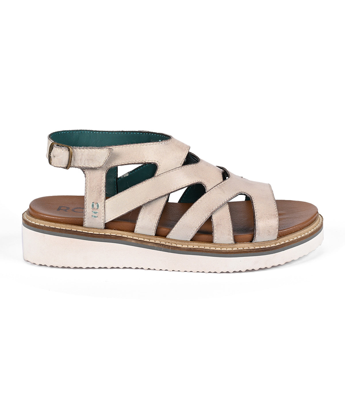 
                  
                    The Centrist by Roan is a beige strappy sandal with a white platform sole and ankle metal buckle closure, offering both style and comfort.
                  
                