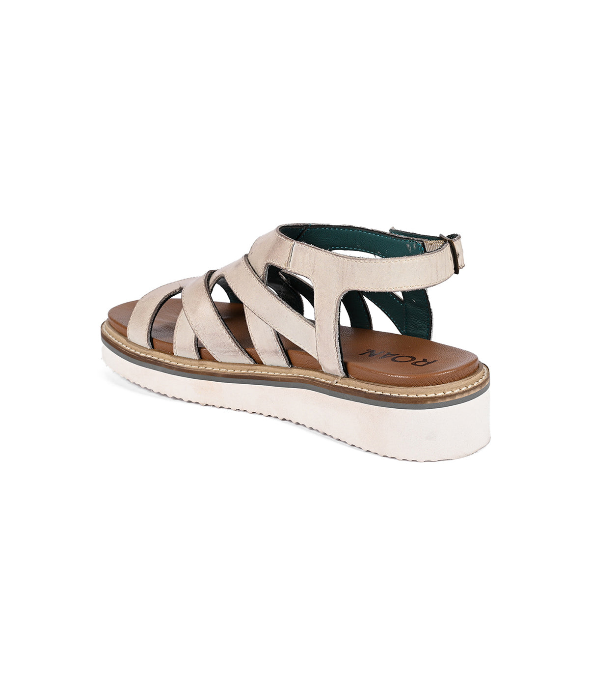 
                  
                    The Centrist by Roan is a beige strappy sandal with a platform sole, closed heel, ankle metal buckle closure, and a soft foam outsole for comfort.
                  
                