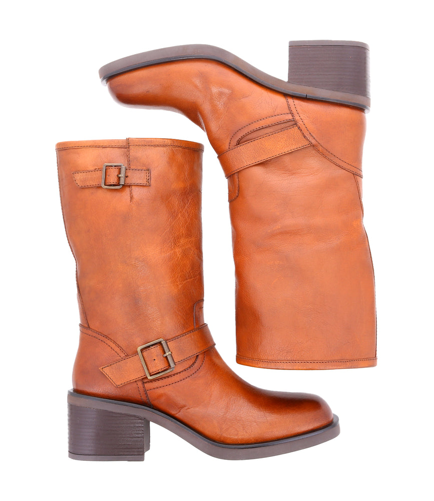 
                  
                    Women's mid-height brown leather boots with side buckles, laid side by side
                  
                