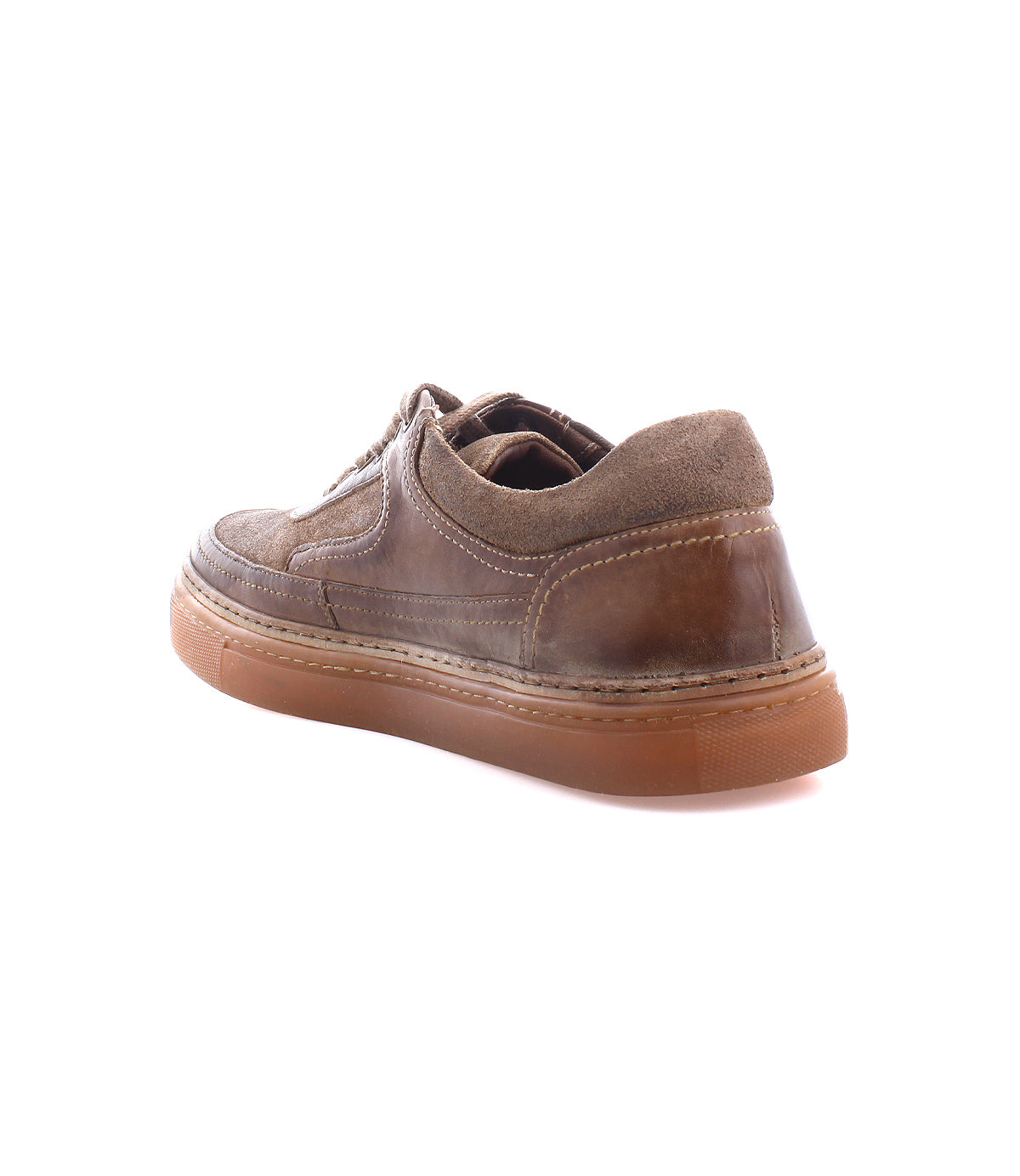 
                  
                    The Roan "Eminent" is a brown leather shoe with a suede collar and rubber sole, shown from the rear. This handmade piece boasts top-grain leather for enhanced durability and style.
                  
                