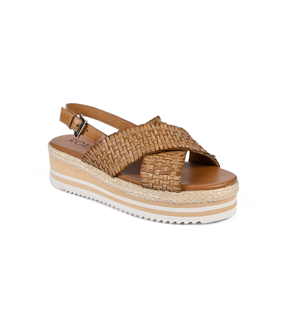 
                  
                    The Roan Into sandal is a brown woven wedge with cross-straps, an adjustable ankle strap, and a white textured platform sole. Crafted with artisanal skill, it features a lightweight serrated foam outsole for optimal comfort.
                  
                