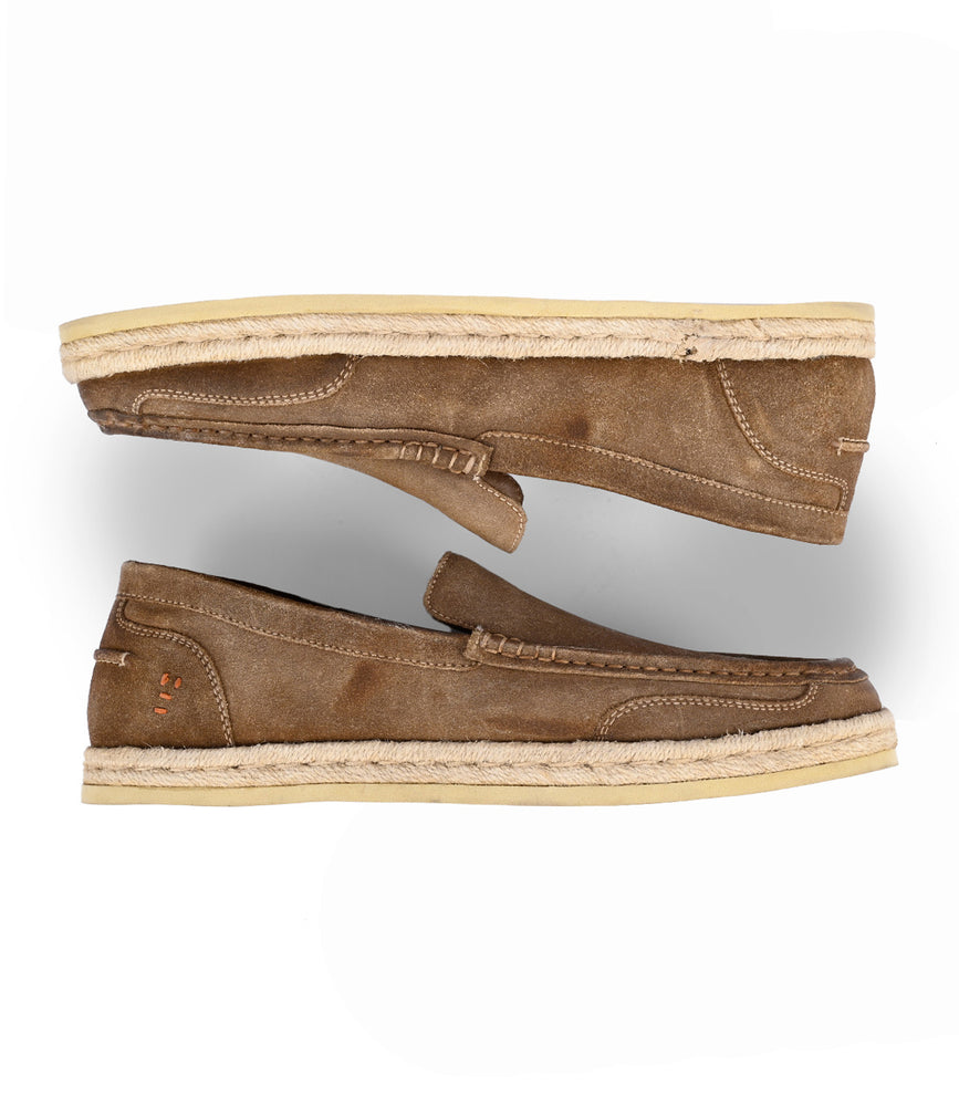 
                  
                    A pair of Roan's Kaboom premium suede slip-on loafers in tan, featuring a suede texture and beige soles, are placed facing opposite directions against a white background.
                  
                