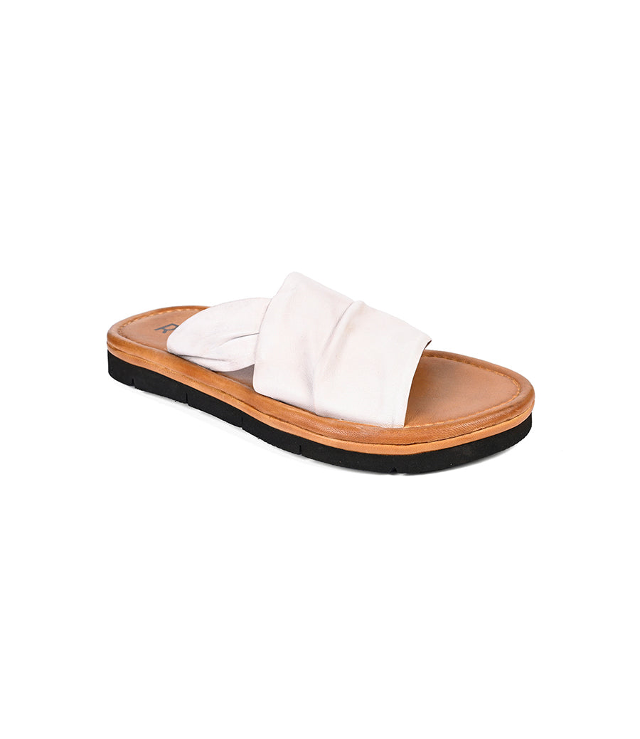 
                  
                    The Nosy by Roan is a white slip-on sandal with leather straps, featuring a tan footbed and black sole, perfect for effortless summer style against a crisp white background.
                  
                