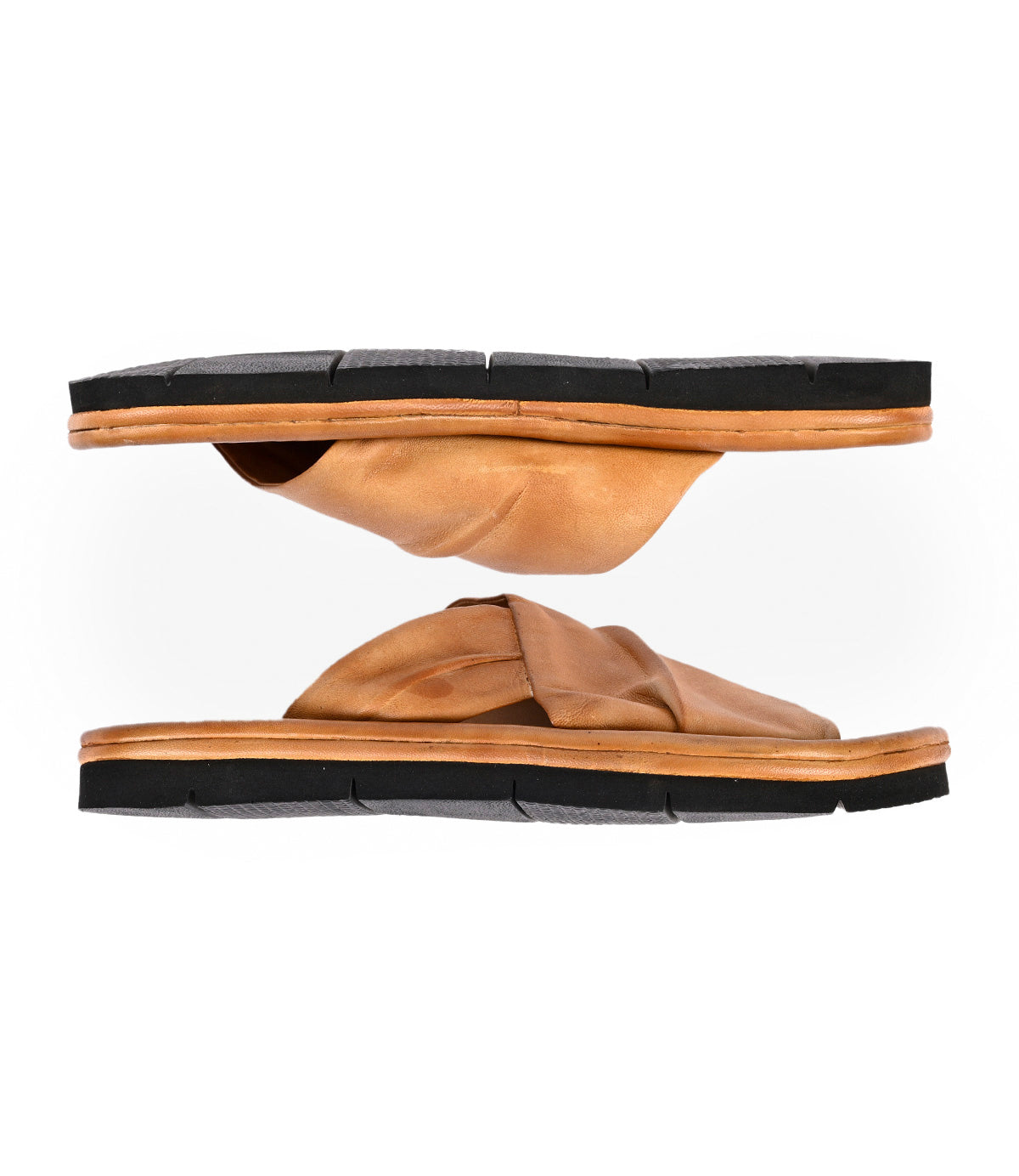 
                  
                    Roan's Nosy tan slip-on sandals feature crisscross leather straps and black soles, displayed horizontally to show top and bottom views on a white background—a perfect choice for effortless summer style.
                  
                