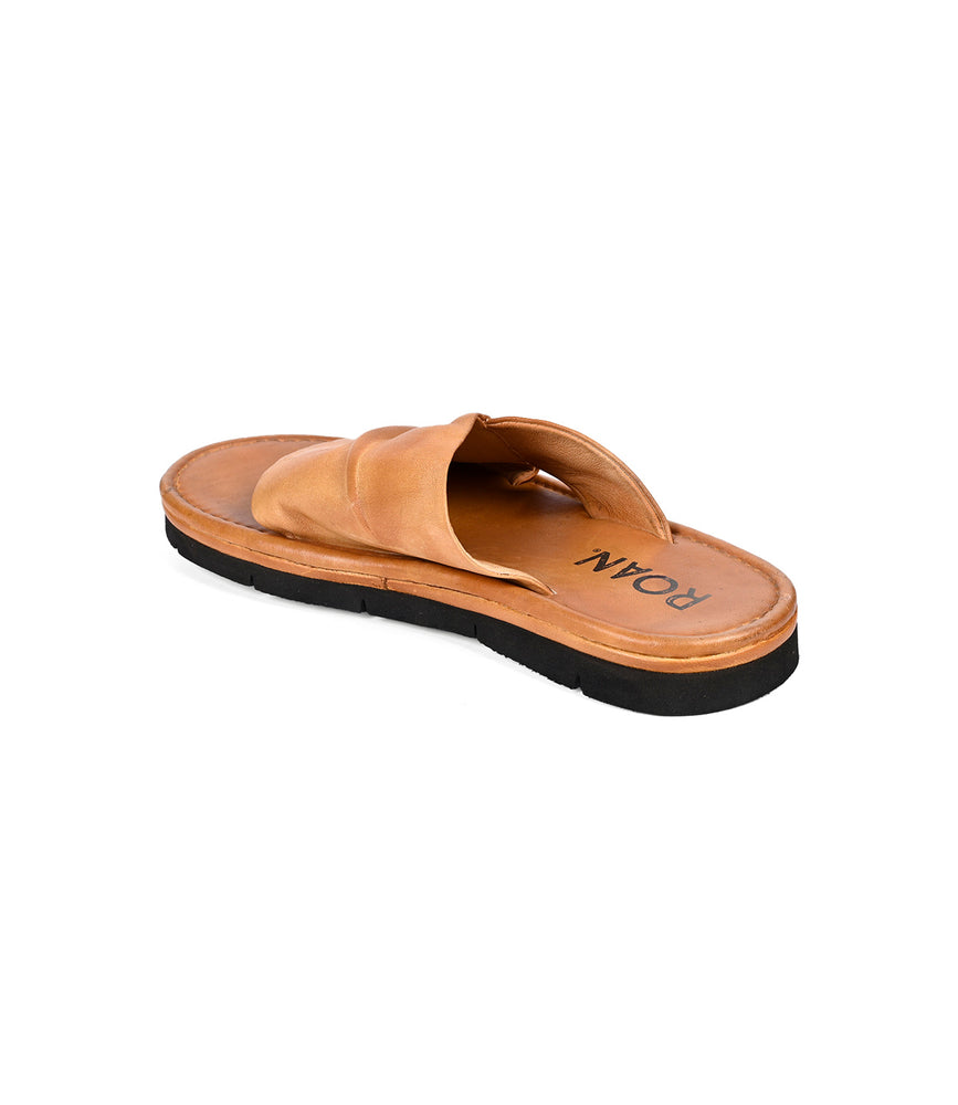 
                  
                    Nosy by Roan is a brown leather slip-on sandal with crisscross straps and a black sole. "ROMA" is featured on the insole, viewed from an angle. Ideal for effortless summer style and comfort.
                  
                