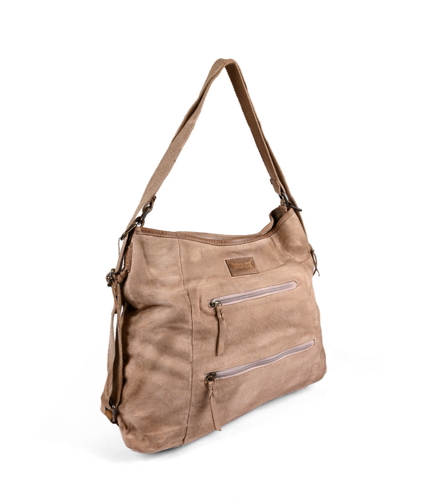 
                  
                    The Roan Oganness is a light brown, casual shoulder bag made from lightweight cotton canvas. It features two front zip pockets and an adjustable strap for convenience. This versatile bag, isolated on a white background, also boasts organizational compartments to keep your essentials neatly arranged.
                  
                