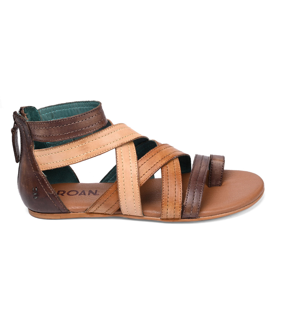 The Roan "Royalty" is a brown and tan leather gladiator sandal with multiple straps, a cushioned footbed, and a back zipper, displayed on a white background.