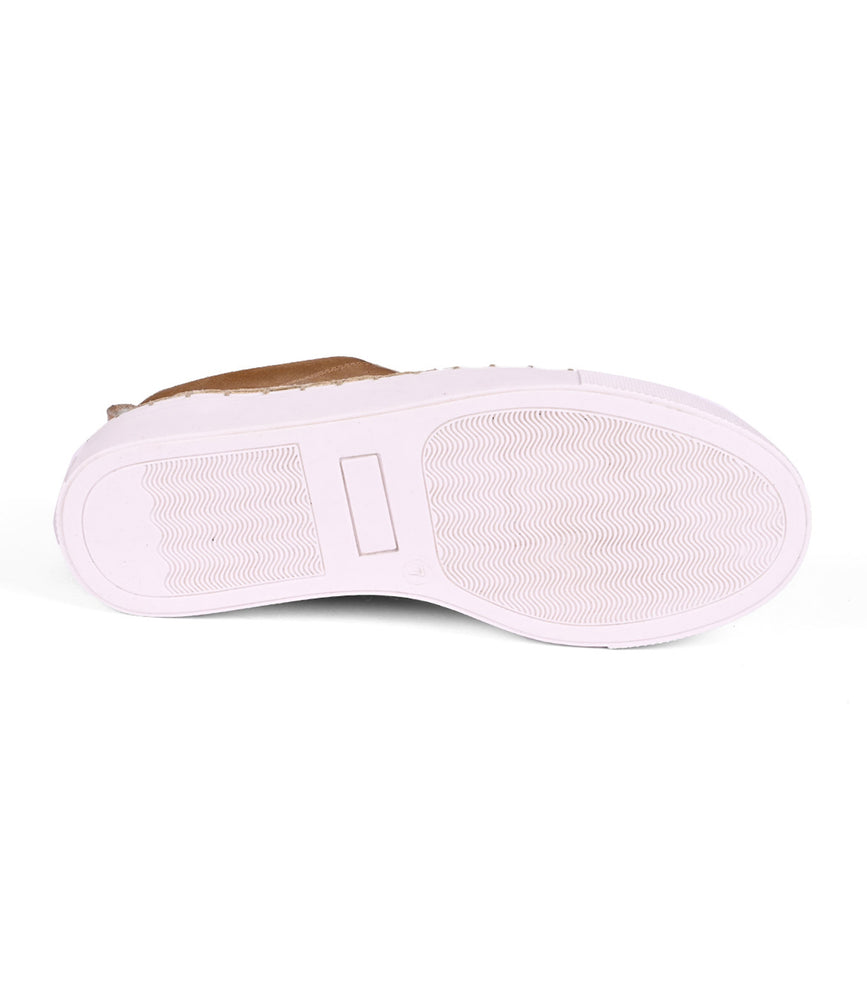 
                  
                    The image features the sole of a Roan "Void" sneaker, a brown lace-up design with a white rubber bottom and textured pattern, lying on its side against a white background.
                  
                