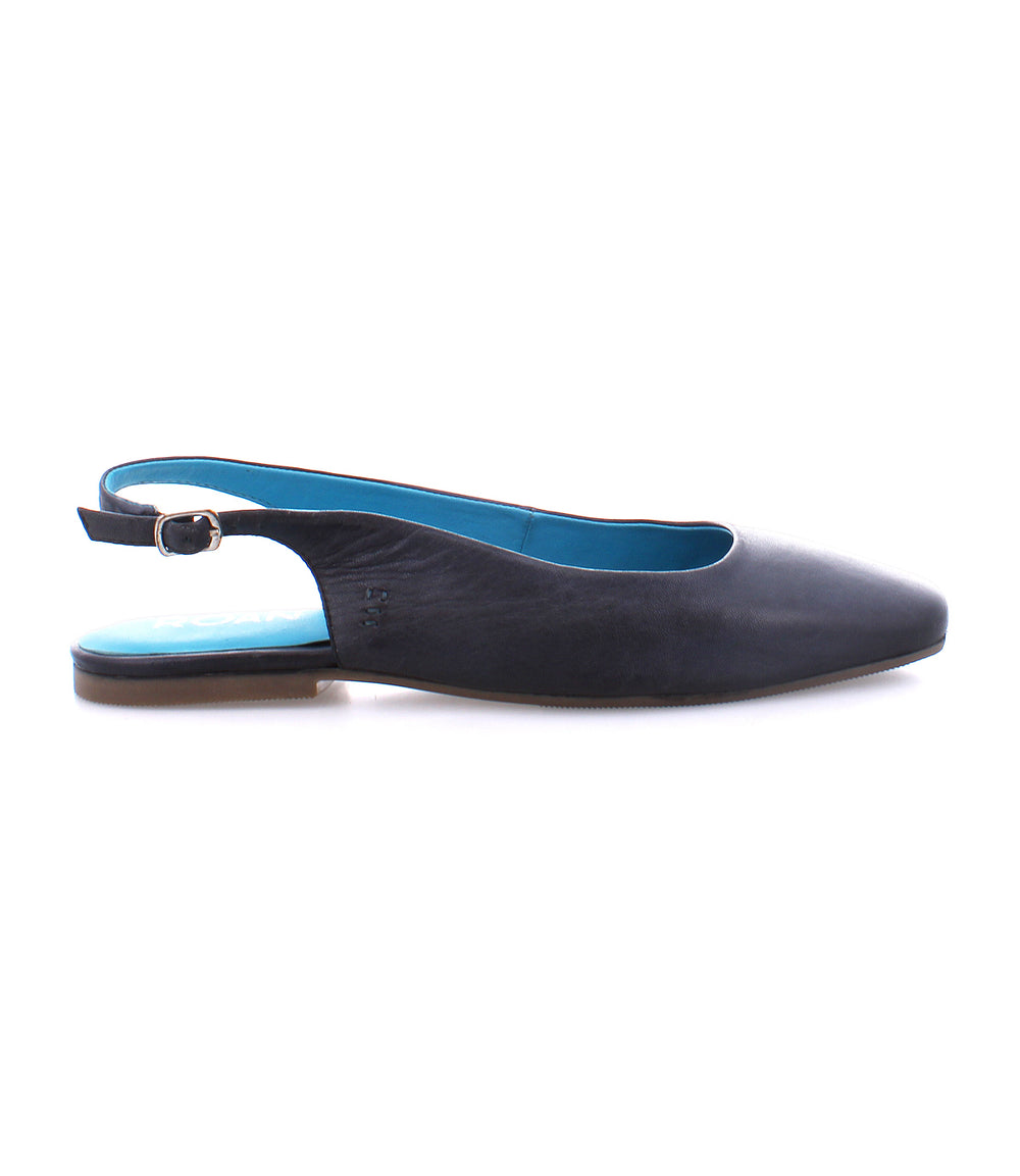 The Roan Woken slingback flat features a black leather upper, blue insole, and buckle strap. Ideal for any occasion.