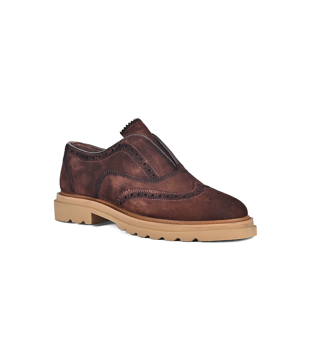 The "Blame" shoe by Roan is a brown suede slip-on adorned with brogue detailing and set on a chunky beige rubber sole.