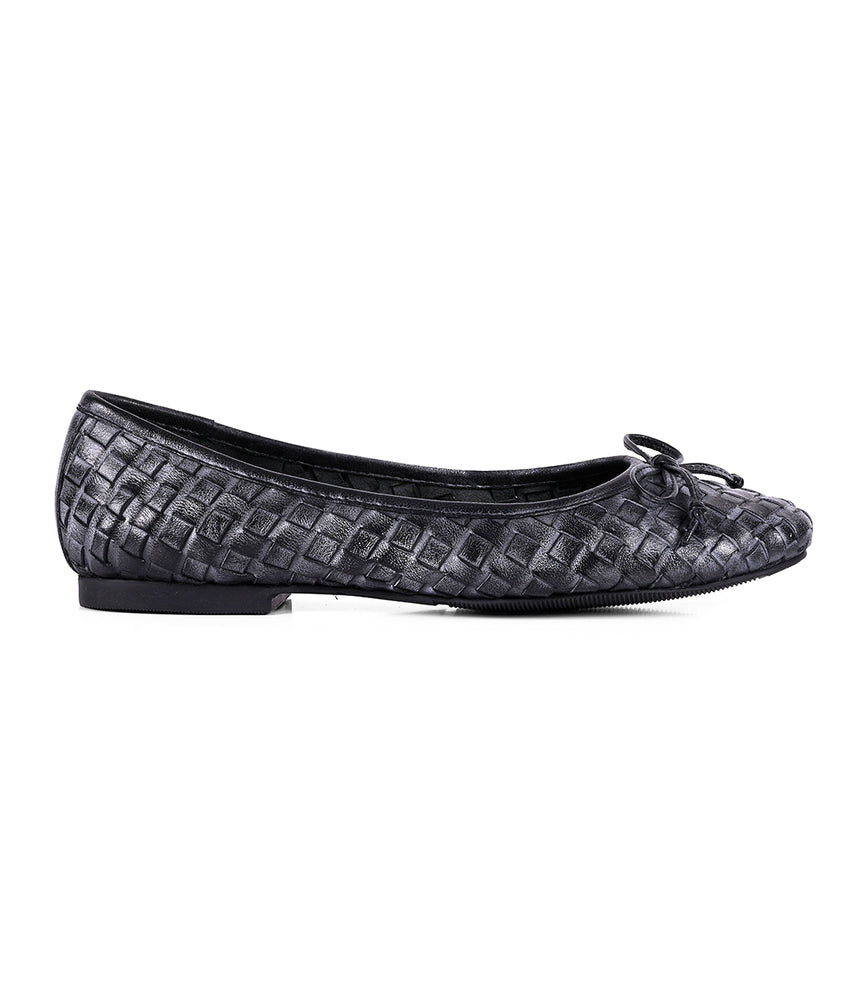 A single black flat slip-on ballerina shoe from Roan's "Business" collection, featuring a woven texture and a small bow on the toe, viewed from the side to highlight its intentional craftsmanship.