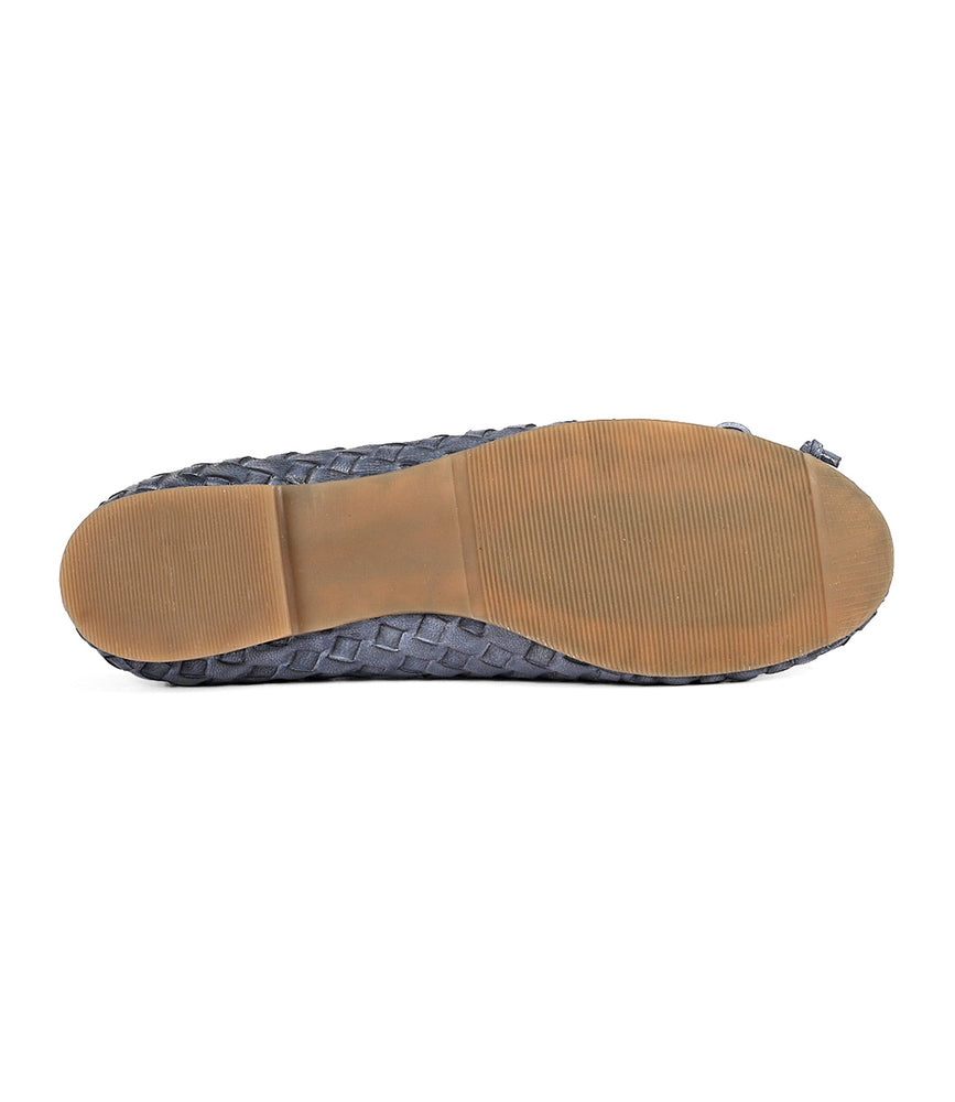 
                  
                    A single gray slip-on ballerina shoe with a hand-woven leather texture, viewed from the bottom showing a brown rubber sole, showcasing intentional craftsmanship. The product is called "Business" by Roan.
                  
                