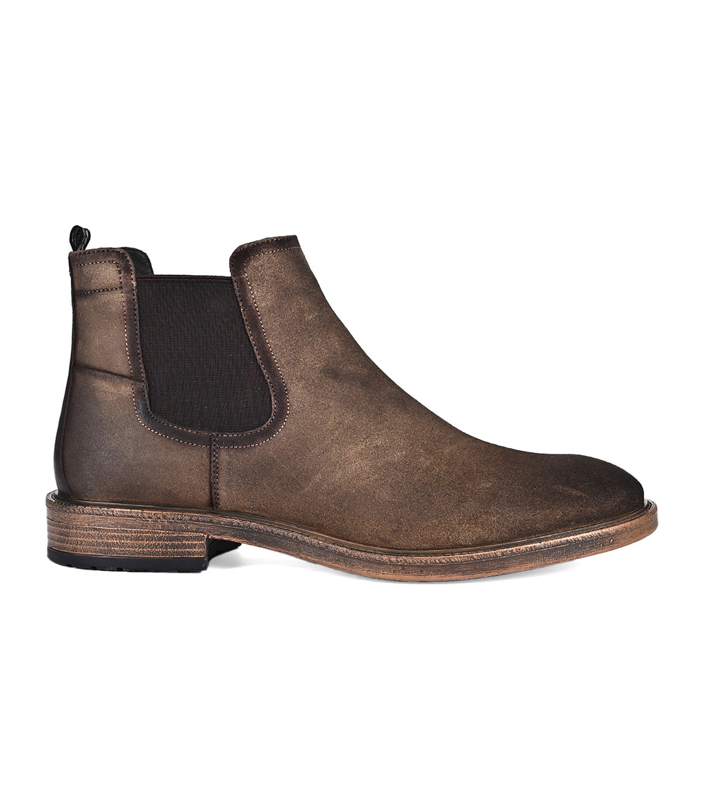 The Jardeen by Roan are versatile suede Chelsea boots in brown leather, featuring elastic side panels and a low heel for an effortless slip-on experience. Photographed on a white background.