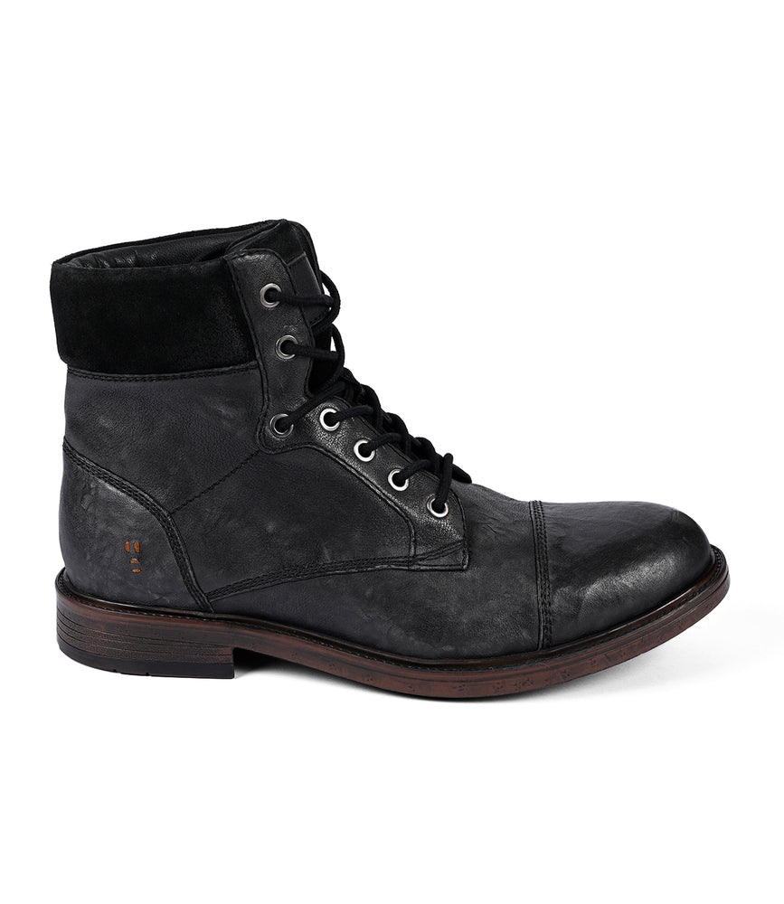 
                  
                    The Roan Lecture is a black men's full-grain leather lace-up boot with a dark wooden sole and rounded cap-toe, featuring a padded collar and stitch details.
                  
                