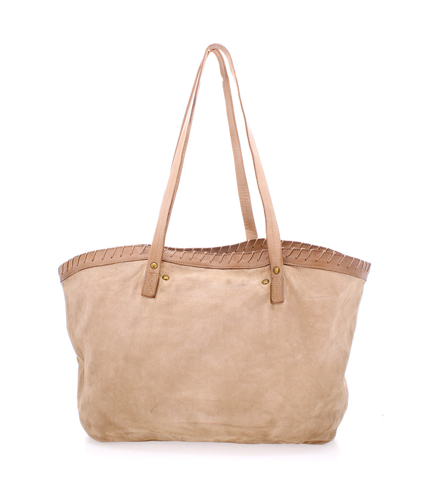 
                  
                    A large beige Roan Rutherford tote bag with light brown stitching along the top edge and two long shoulder straps. The handmade cotton canvas tote appears to have a soft, suede-like texture.
                  
                