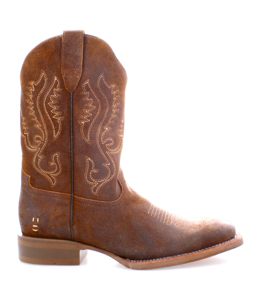 The Roan Saber is a brown cowboy boot made from full-grain leather, featuring decorative stitching, a rounded toe, and a low heel, shown in profile.